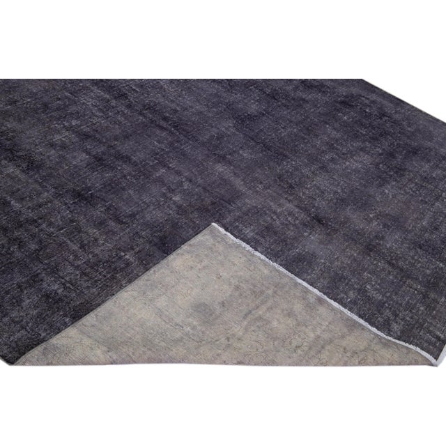 Beautiful Vintage Overdyed hand-knotted wool rug with a gray field. This Persian rug has black accents in an all-over...