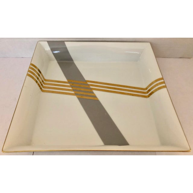 Vintage large Daniel Hechter porcelain square cathcall, in angular/diagonal grey and gold accents.Daniel Hechter, Parisian...