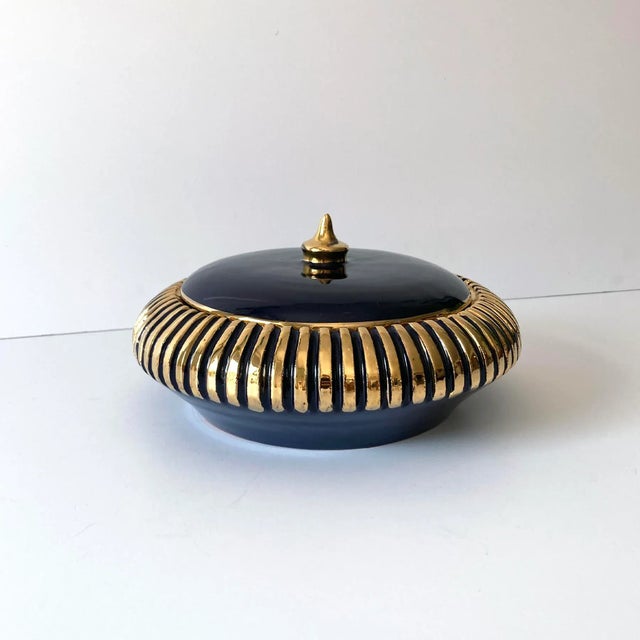 Beautiful Italian navy and gold round lidded box. The dark blue shade contrasts beautifully with the gold ribbed accents...