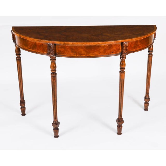 This is an elegant English burr walnut Parquetry console table dating from the 1950's. This demi-lune magnificent piece is...