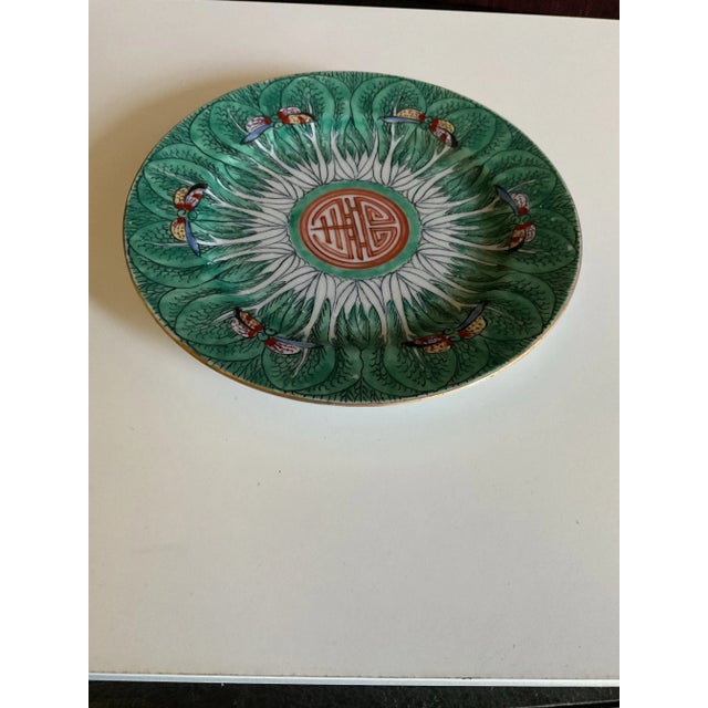 The plate was made in Hong Kong and comes in different sizes. This is a smaller size with a 6.5" diameter. The green color...