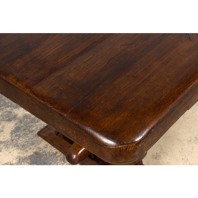 A substantial 19th century French farmhouse dining table crafted from solid oak and featuring an impressive single slab...