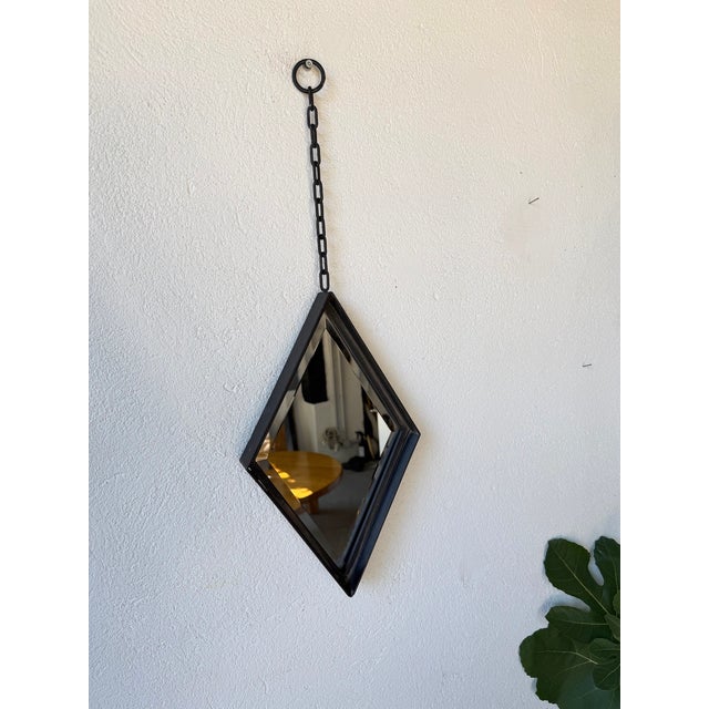 Antique Brutalist wrought iron diamond-shaped mirror with its original hanging chain. The mirror is beveled, lending the...