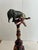 Delightfully whimsical found object sculpture with vintage elephant and clown on top of a rustic carved wood finial, with...