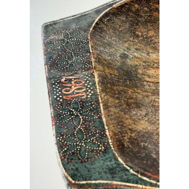 A Danish communal bowl made of partially painted wood. Mid-19th century. The owner's initials, KJPS, and the...