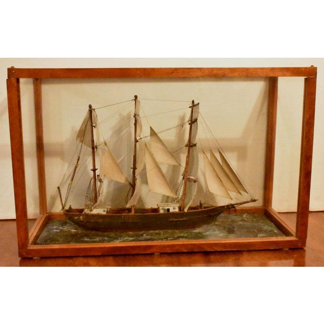 19th century ships model under full sail. A folk art piece, this is done of carved wood and thread rigging sitting on a...