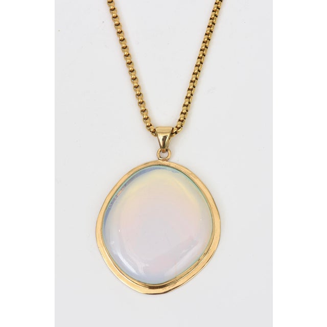 This gorgeous 1980's gold plated long pendant necklace with a large glass iridescent stone is in the color of Tiffany blue...