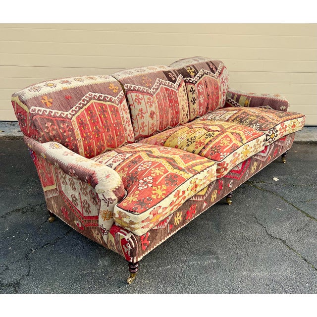 George Smith Standard Arm sofa in beautiful kilim with down wrapped seat cushions on turned legs with brass casters.