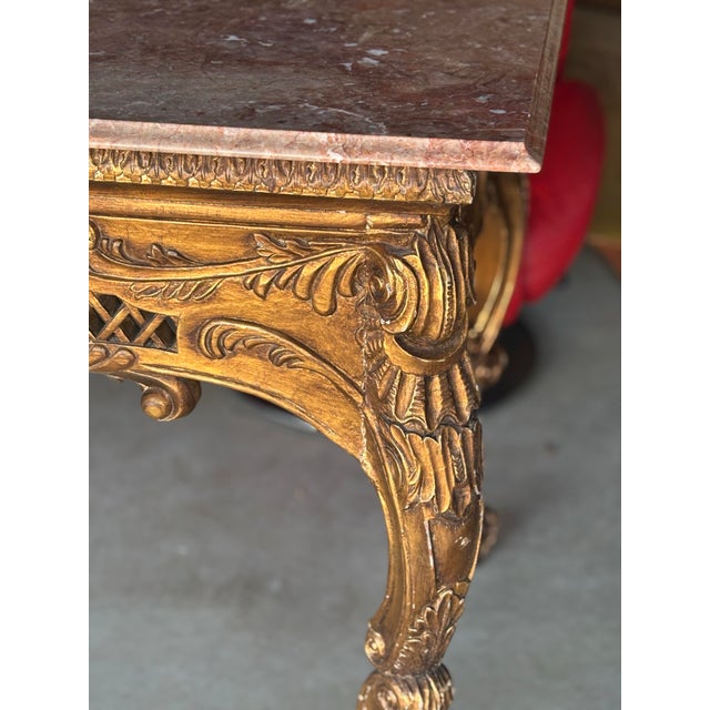 Infuse your home with unmistakable French elegance with this Louis XIV–style gilded wood console table, adorned with a...