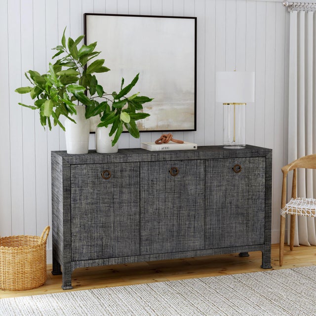 This gorgeous sideboard is beautifully crafted and topped with a layer of woven raffia for a look that feels both tactile...