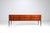 Elegant Italian sideboard or chest of drawers, produced in the 1960s. Crafted in warm-toned teak, the piece is defined by...