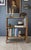 An antique farmhouse bucket-bench-style bookshelf featuring bracket feet defined by graceful ogee arches on each side....