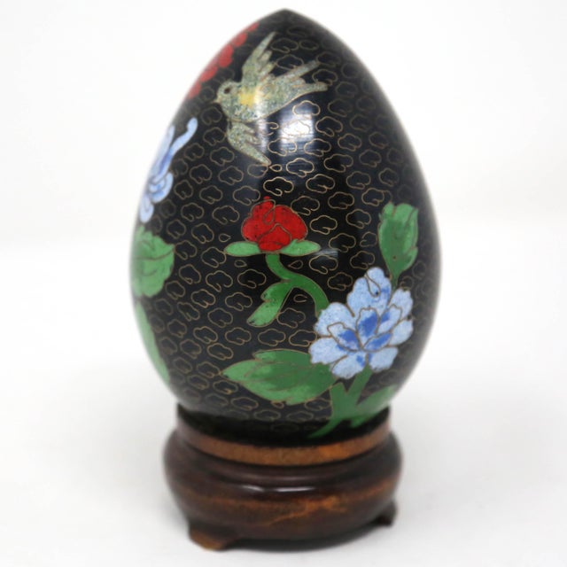 A beautiful handmade cloisonne egg, skillfully adorned with flowers and birds. Includes the wooden display stand.