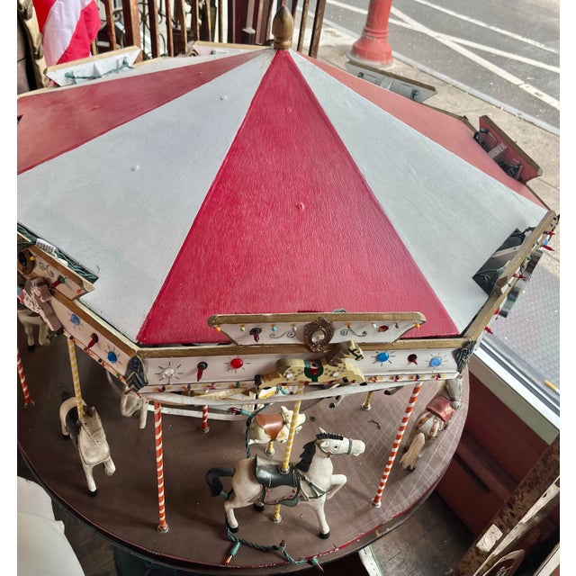 A rare find. Hand crafted 1940’s revolving carousel with horses and other animals: lion, pig, elephant and bear. Golden...