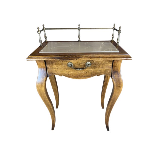 This french provincial end table is so charming. It is a light wood with a single drawer and cabriole legs. The top is...