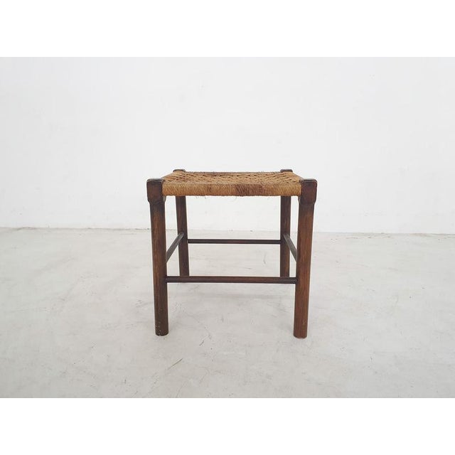 About this item Wooden stool with rattan seating. The rattan has some stains.