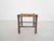 About this item Wooden stool with rattan seating. The rattan has some stains.