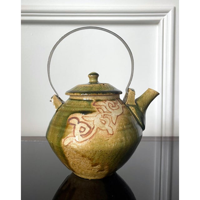 A contemporary studio ceramic tea pot with metal handle made by Japanese potter Ken Matsuzaki (1950-). The stoneware tea...