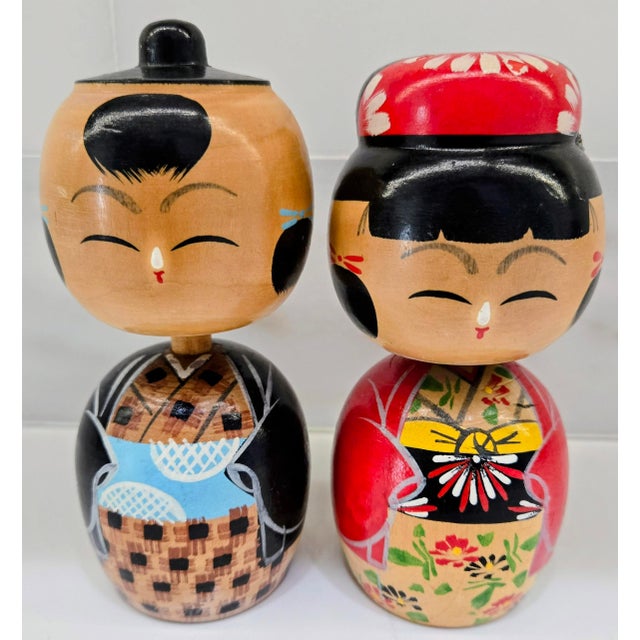 Celebrate Japanese folk art and wedding tradition with this charming vintage pair of Japanese kokeshi dolls depicting a...