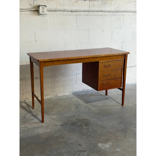 This teak vanity combines a broad work surface with a flip-up mirror, divided storage compartments, and three drawers. A...
