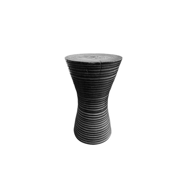 Handcrafted from a single block of solid suar wood, this sculptural side table pairs organic materiality with a refined,...