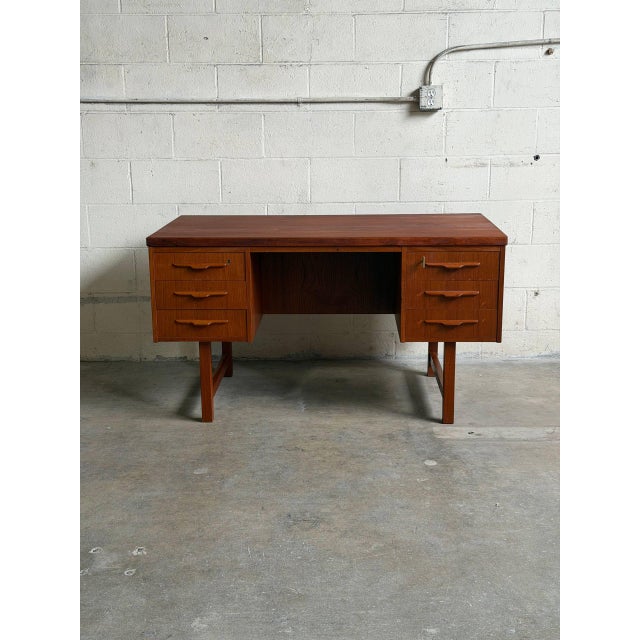 Beautiful vintage Scandinavian Modern executive desk crafted in warm teak in Denmark. This elegant Mid-Century Modern desk...