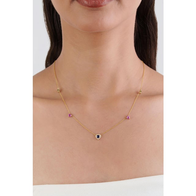This heart pendant necklace features 1.58 ct of natural heart-shaped pink, blue & green sapphires, set in 14K yellow gold....