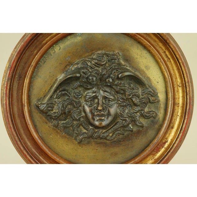 Description of the item: A wonderful gilded bronze sculpture depicting the face of Medusa in bas-relief, with a circular...