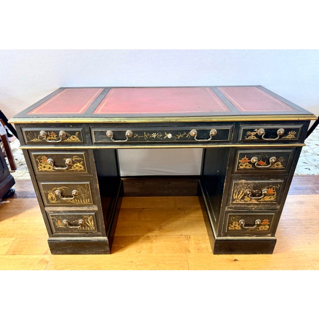A dramatic vintage black chinoiserie desk with a richly detailed, hand-painted finish and wonderfully tailored silhouette....