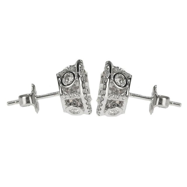One pair of platinum earrings containing two modern round brilliant diamonds weighing approximately 3.70 carats total...