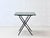 This folding table combines timeless design with practical functionality. The square metal tabletop in a subtle green...