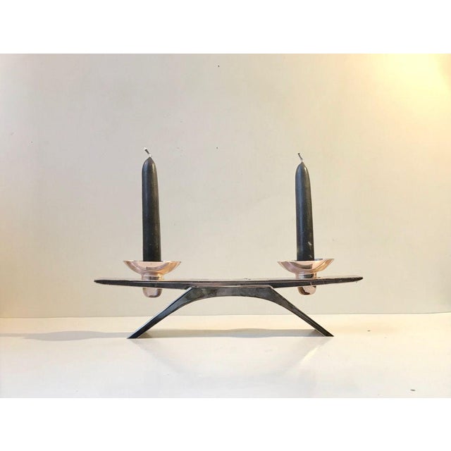 Perfectly balanced small candleholder for two candles. It is made from silver plated metal and features the Ikora pattern...