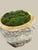 A large planter hand-carved from a single piece of raw onyx, the rugged natural outer edge left intact against a smoothly...