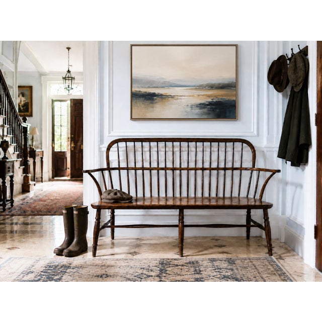A beautifully crafted handmade wooden spindle bench with timeless Windsor-inspired lines. This piece features a long,...
