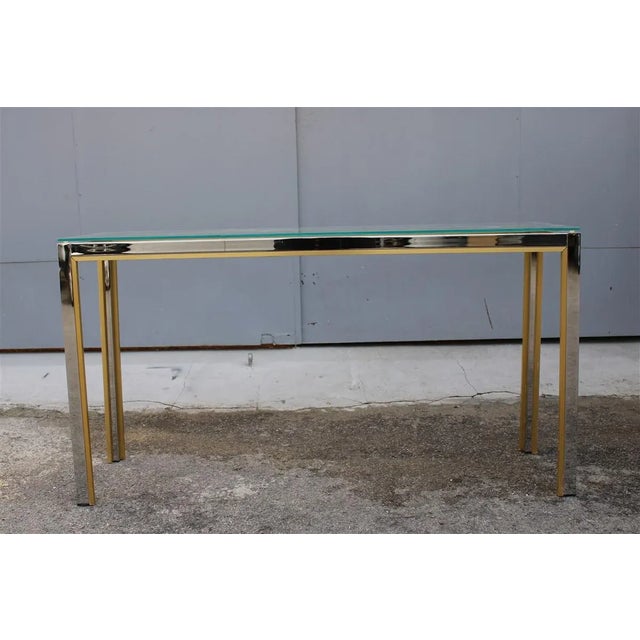 Minimalist Brass and Chrome Console Table, 1970s, in Very Good conditions. Designed 1970 to 1979 This piece is designed in...