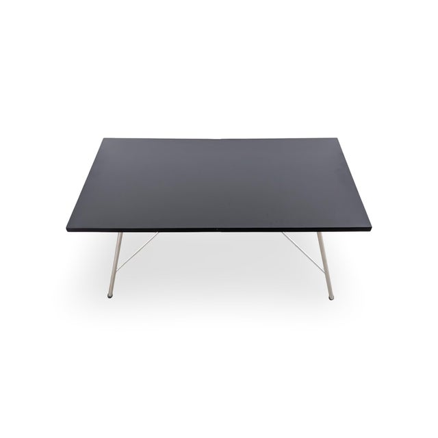 Beautiful vintage coffee table from the 1960s for sale. The table features folding legs and a refurbished, black lacquered...