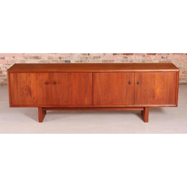 Mid Century teak sideboard by Gordon Russell, circa 1960s. Three cabinets with shelves and one with 2 drawers. Excellent...