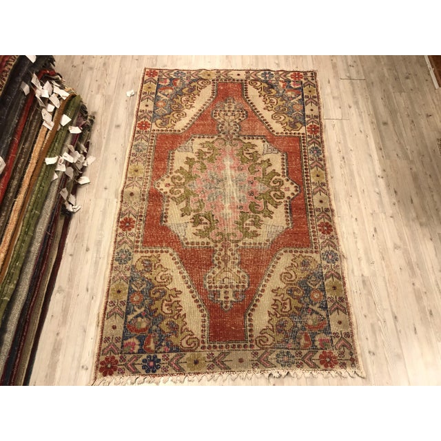This is a vintage Turkish Oushak rug from the 1960s. The piece was hand-knotted.