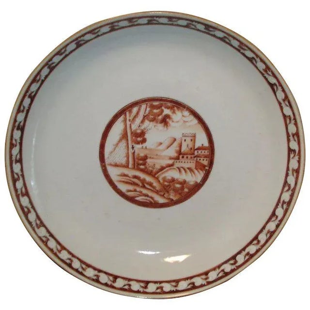 A wonderful export plate or bowl decorated with a central reserve depicting a landscape in sepia tones. Nice orange peel...