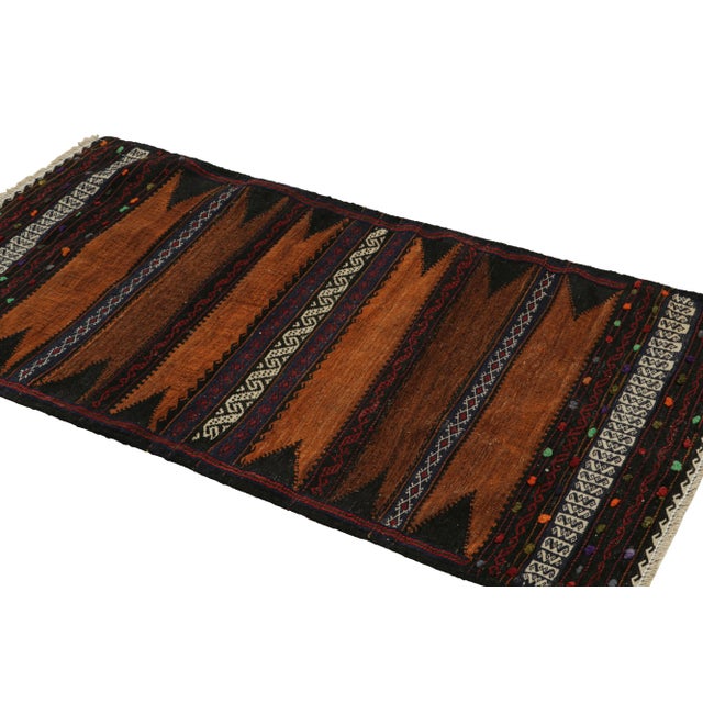 Handwoven in wool, this 2x5 vintage Afghan kilim rug originates circa 1950-1960—a tribal curation among new additions to...