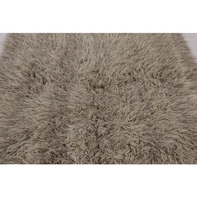 Hand-knotted in wool and originating from Turkey circa 1950-1960, this 5x7 vintage Tulu rug is a rich new minimalist piece...