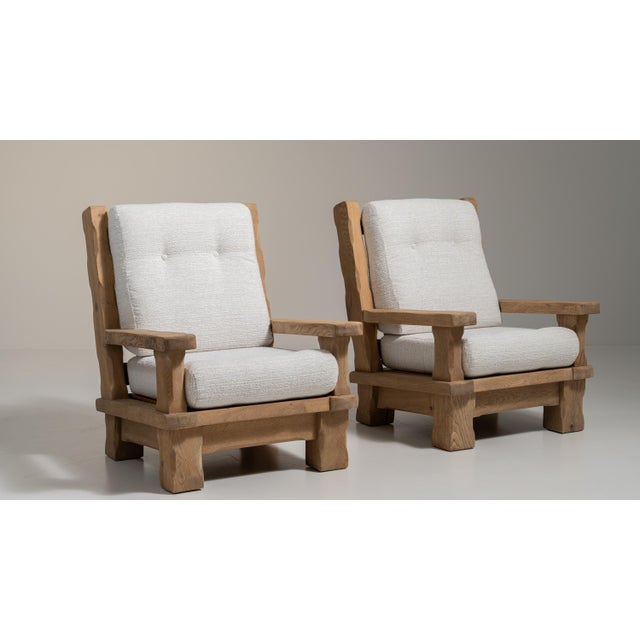 A cream wood, Brutalist-style armchair, dating to the 1970s and made in France. The wood frame is finished in fabric,...