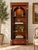 Elegant Neoclassical Empire-style bookcase by Maitland-Smith, handcrafted in the Philippines in 2015. Featuring a richly...