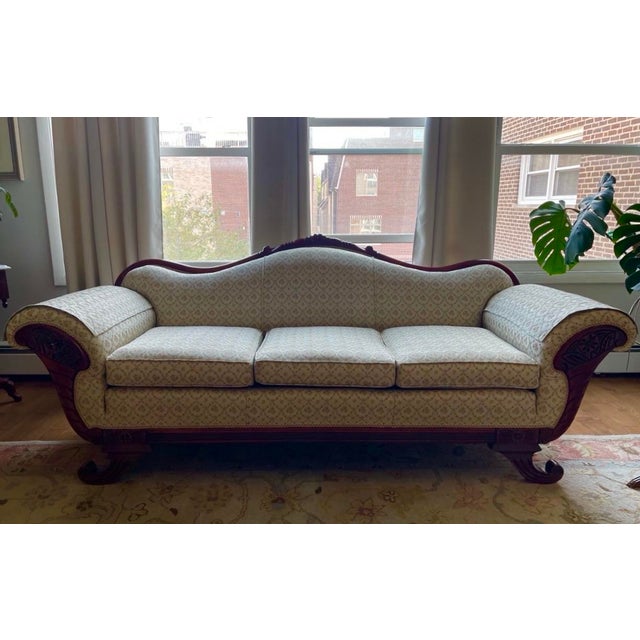This beautifully preserved Victorian-style camelback sofa, which resembles later “Duncan Phyfe-style” reproductions from...