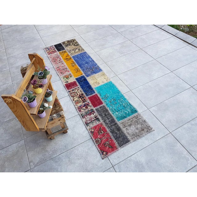 This is a vintage Turkish Oushak rug from the Mid 20th Century. The piece was hand-knotted.