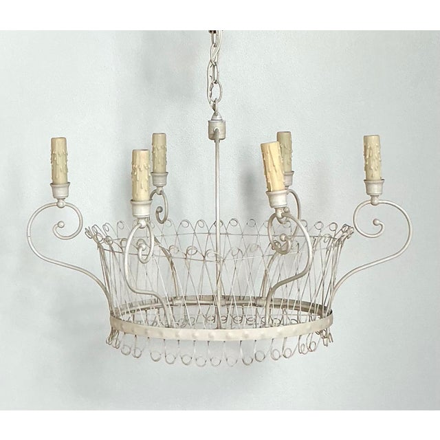 Illuminate your home with the whimsical charm and airy elegance of this vintage wire basket chandelier. Evoking the...