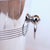A pair of silver-plated champagne buckets with banded detail and ring handles set on a silver-plated, weighted stand....