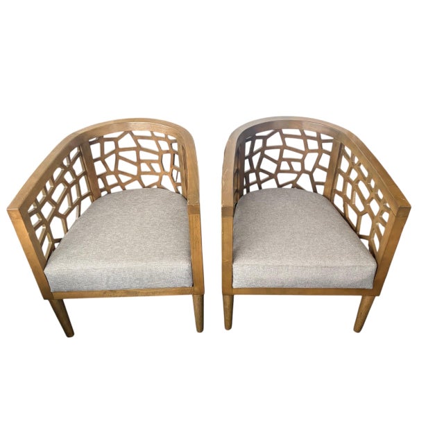 Add a striking architectural element to your seating arrangement with this handsome pair of barrel-back tub chairs....