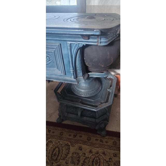 A stunning antique Poêle à Bois Godin in cast iron with a beautiful aged green enamel finish and exceptional decorative...
