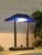 A graphic vintage desk lamp with a distinctly postmodern profile, pairing a vivid cobalt blue shade with a matte black...